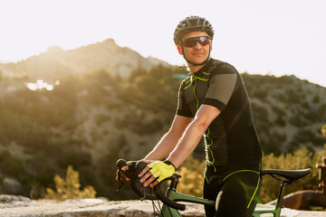 Portrait of male caucasian cyclist with helmet and glasses
