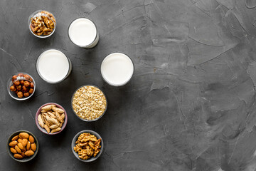 Fototapeta na wymiar Vegan alternative nuts milk in bottles. Above view
