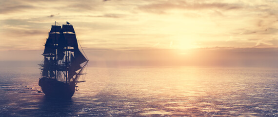 Pirate ship sailing on the ocean at sunset