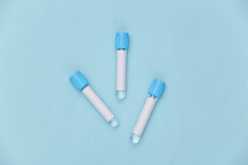 Medical test tubes on blue background. Top view