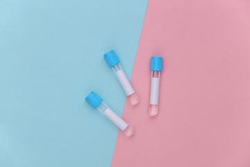 Medical test tubes on pink blue pastel background. Top view