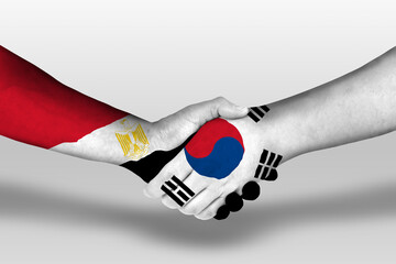 Handshake between south korea and egypt flags painted on hands, illustration with clipping path.