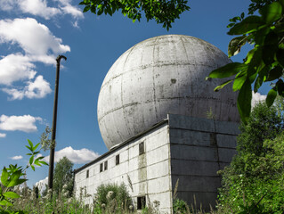 Obraz premium A man stands on the roof. White ball for locators in Russia. 
