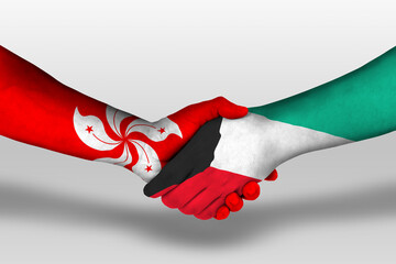 Handshake between kuwait and hong kong flags painted on hands, illustration with clipping path.