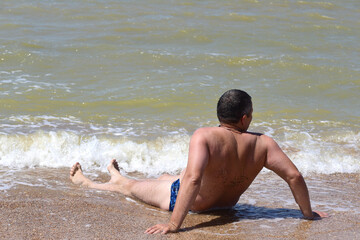 Fototapeta na wymiar a man lay on the beach