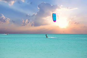 Surfing at sunrise at Aruba island in the Caribbean Sea