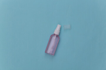 Antiseptic bottle on a blue background. Top view
