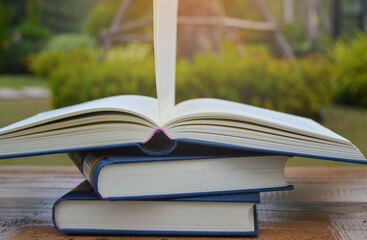 Open a book on a wooden floor in the middle of nature