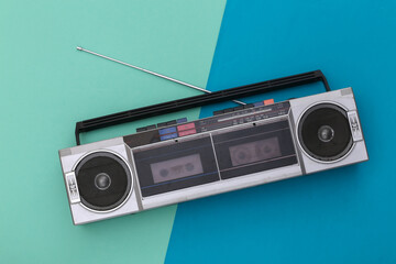 80s Retro Outdated Portable Stereo Radio Cassette Recorder on Blue Background. Top view