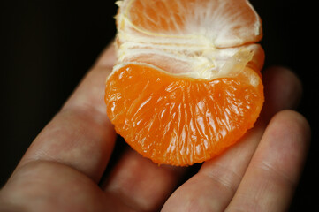 ripe and juicy mandarin. fresh mandarin in hand, closeup
