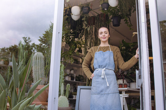 Small business store owner opening up plant shop