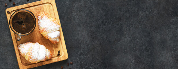 Croissants on a wooden board with coffee paste. View from above.