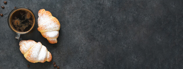 Croissants with espresso on a black concrete background. view from above.