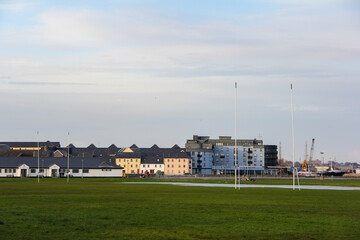 Fototapeta premium Rugby field in the middle of a meadow and with buildings in the background in Galway, Ireland