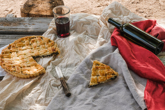 picnic. Pie and wine on the table, rustic style.