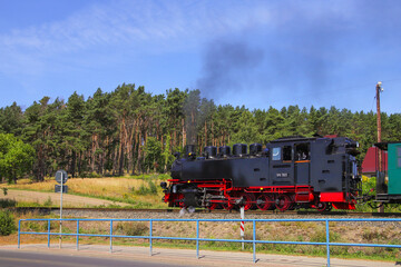 Fototapeta na wymiar The old steam narrow-gauge railway locomotive of the island Rügen in Sellin, Baltic Sea - Germany 