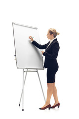 Working with flipchart. Young woman, accountant, finance analyst or booker in office suit isolated on white studio background. Caucasian woman, office worker. Finance, economy, professional occupation