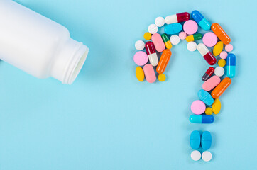 A question mark from laid out of medicine pills with bottle drug.