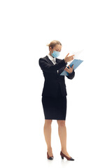 Working in face mask. Young woman, accountant, finance analyst or booker in office suit isolated on white studio background. Caucasian woman, office worker. Finance, economy, professional occupation.