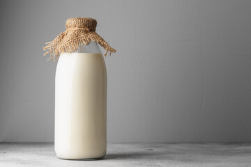 Closed blank glass bottle of milk, front view