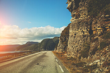 The highway along fjord at sunset. View from the windscreen. Beautiful nature of Norway
