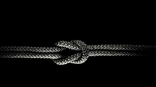 Reef knot black rope on a black background. Stock Photo