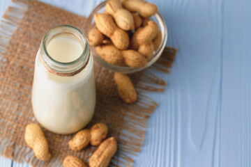 Vegan peanut milk in glass with peanuts