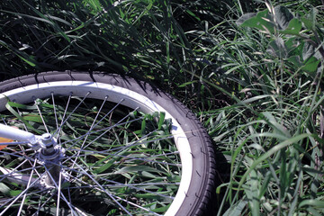 Bicycle wheel on grass. Summer background. Selective and soft focus.