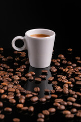 Mugful of coffee in white cup and saucer with coffee grains background