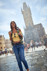 Girl with a backpack traveling and enjoying summer at raining day.