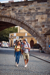 Fototapeta na wymiar Man and woman in love walking in the streets of Prague.Travel, tourism and people concept.