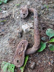 Old rusted door handle on the ground.Rusty Old Door Knob on Ground.An old metal door handle knocker.
