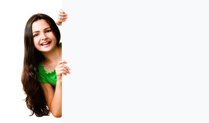 Very happy excited cute little girl in green smart casual clothing showing blank banner signboard. Success and advertising concept. Copy space empty place for some text. Isolated over white background