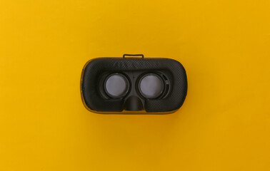 Virtual reality headset on yellow background. Top view. Flay lay. Minimalism