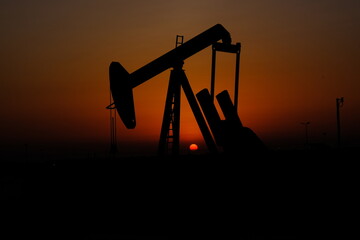 oil pump in sunset with sunset in Bahrain