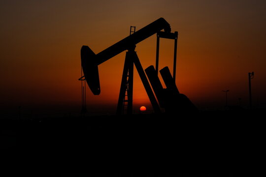 oil pump in sunset with sunset in Bahrain