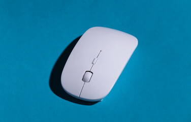 Pc mouse on blue background with shadow.