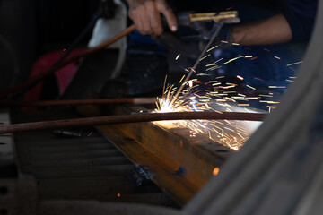 Worker,welding in a car factory with sparks, manufacturing, industry