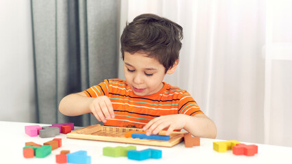toddler boy playing indoors with educational toy.