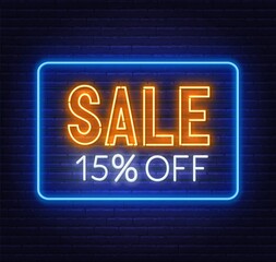 Sale 15 percent off neon sign on brick wall background. Discount.
