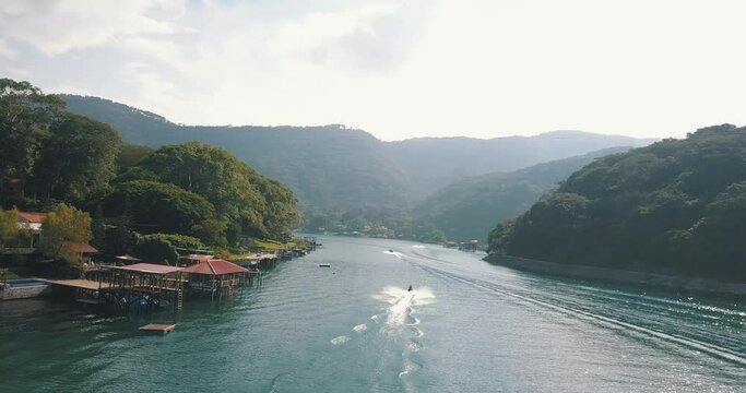 Aerial drone shot of Jetski cruising the lake during summer