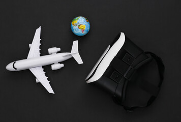 Virtual travel. Virtual reality headset with plane, globe on black background. Top view