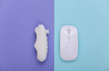 Pc mouse with joystick on purplish blue pastel background. Top view