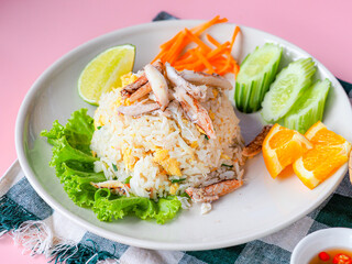 Crab fried rice in white plate on pink background, fast food concept