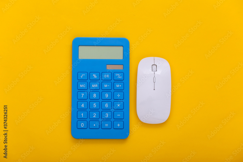 Poster pc mouse with calculator on yellow background. top view