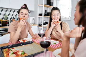 Friends eating delicious homemade pizza