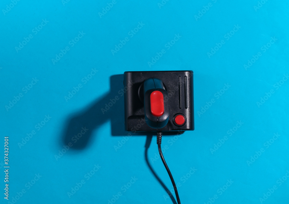 Poster retro joystick on a blue background with a shadow. retro gaming. top view