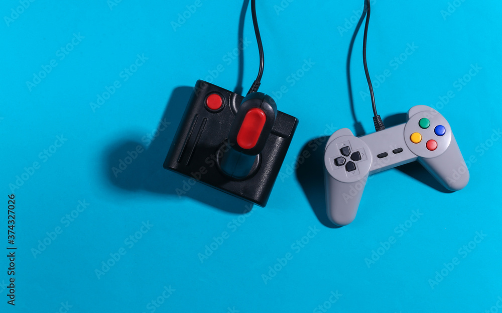 Poster retro joystick and gamepad on a blue background with shadow. retro gaming. top view