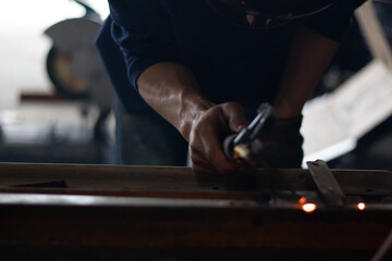 Worker,welding in a car factory with sparks, manufacturing, industry