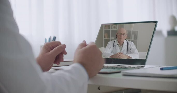 videochat of two doctors in offices of hospitals, consultation of medical colleagues, modern technology of communication